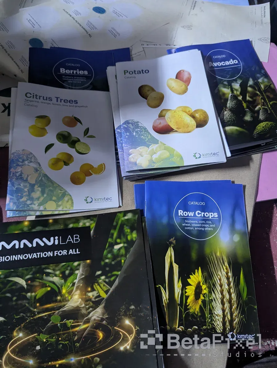 Spread of printed brochures for crop products covering berries, citrus, potato, avocado and row crops