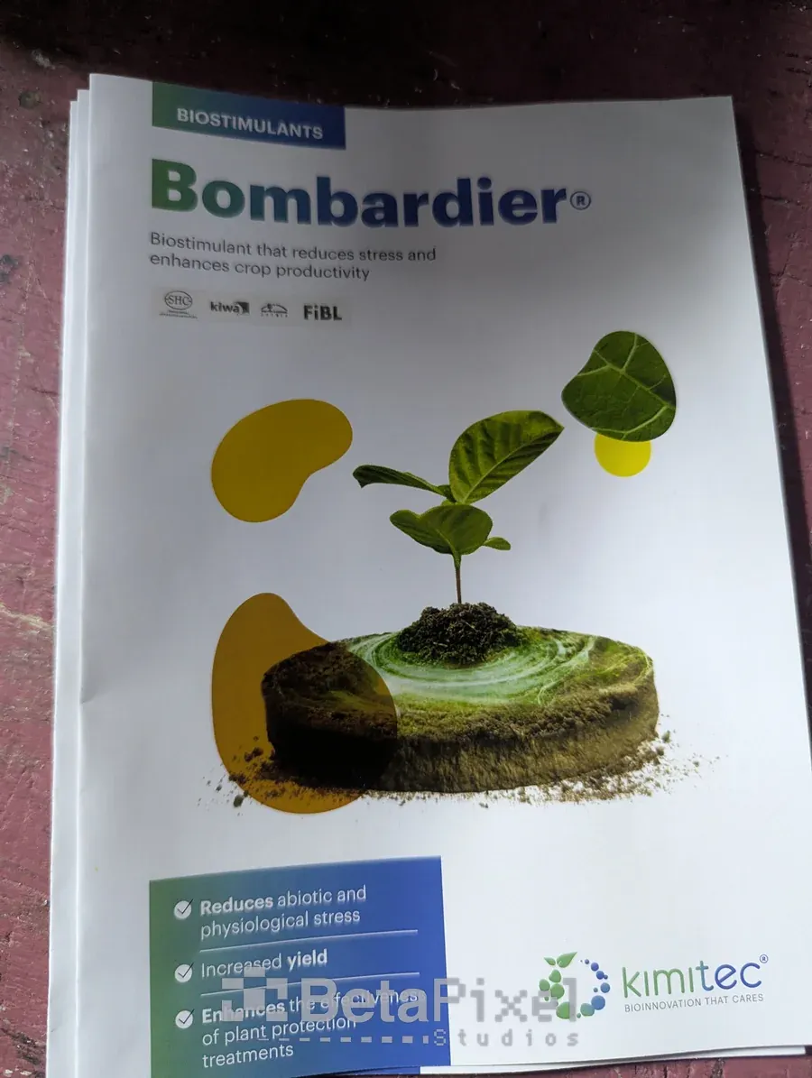 Stack of printed A4 brochures for an agricultural biostimulant product with a plant illustration