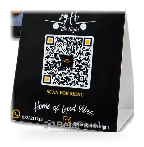 Black table tent card with a white scan-for-menu QR code and social handles