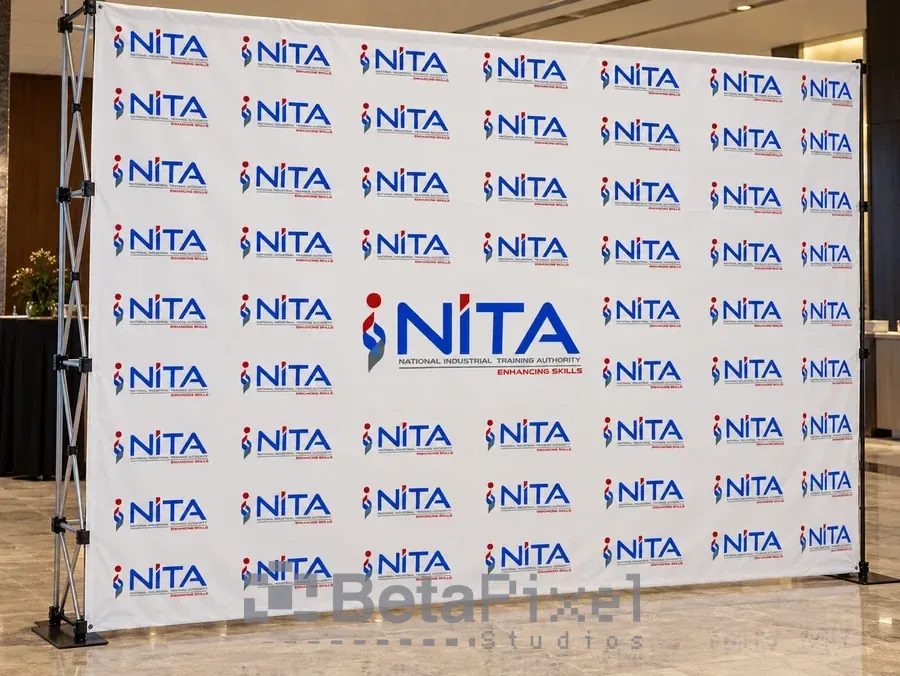 Step-and-repeat media backdrop banner with a repeating training authority logo on a portable pop-up frame
