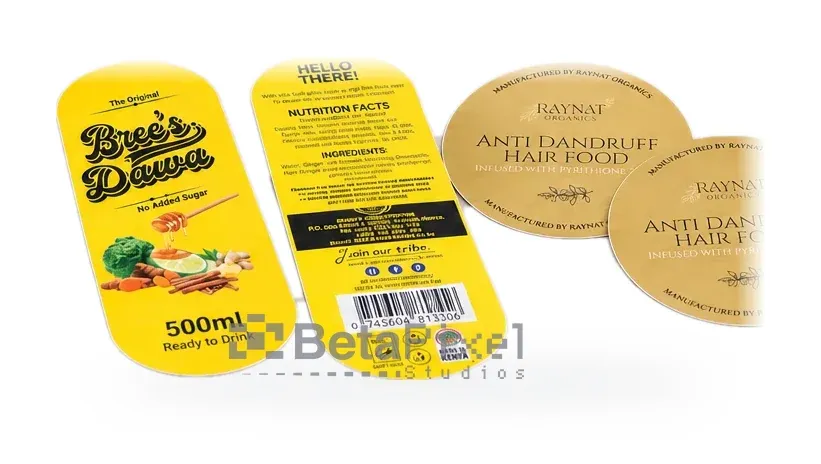 Loose die-cut product labels: a drink front and back label with nutrition facts and barcode, and round gold lid labels