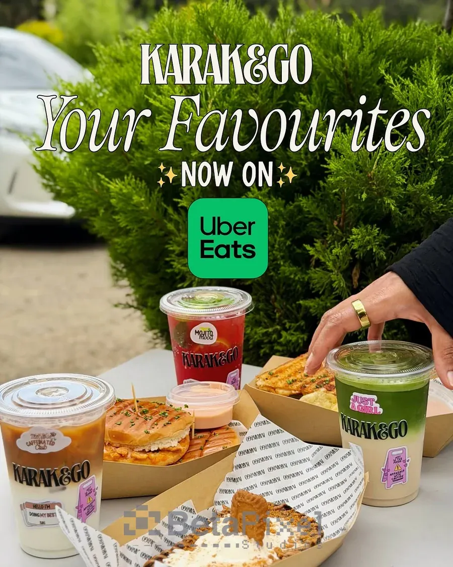 Branded takeaway cups, food boxes and printed wrap paper for a cafe, shown in a delivery launch photo