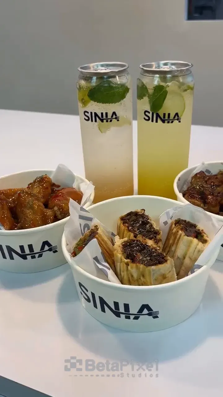 Short video of a restaurant opening with branded drink cans, printed food bowls and Indulge in Flavour wall lettering