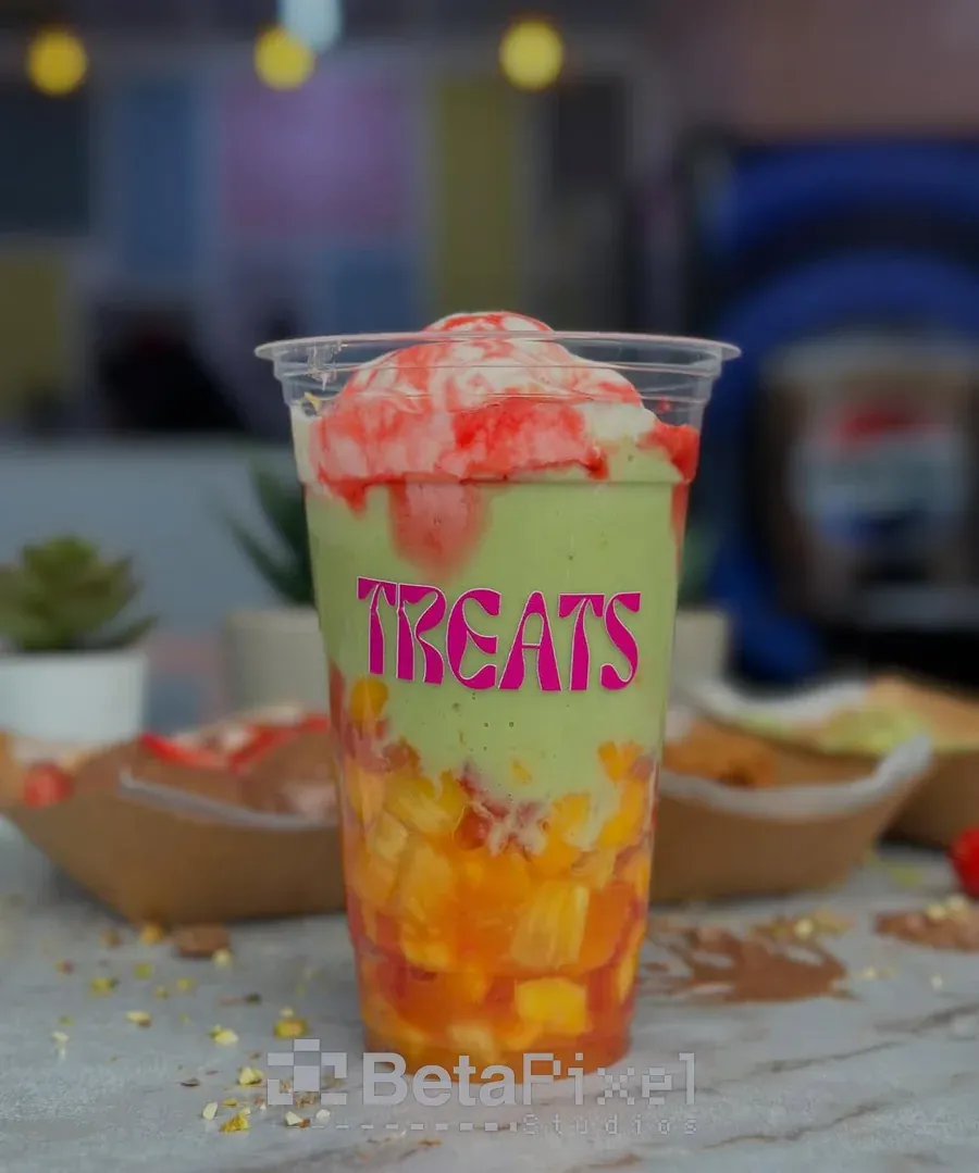 Clear takeaway dessert cup printed with a bold pink Treats logo, filled with fruit and ice cream