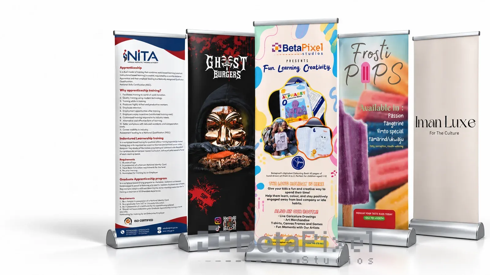 Five printed roll-up banners on silver stands for a training authority, restaurants, a book launch and a fashion brand