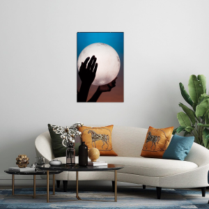 Manipulated image of ladys hands holding a moon